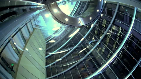 Ascending by floors vertical glass contemporary city elevator at night in modern Stock Footage