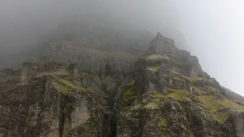Ascending into the Fog Facing a Large Mountain Stock Footage 130134970