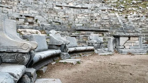 Ascending forward view from the altar to the stairs of Priene ancient theater Stock Footage 103987470