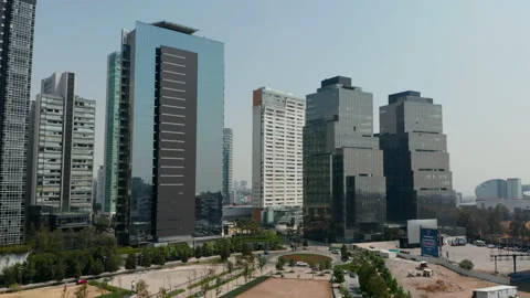Ascending forwards fly against group of tall modern buildings. Skyscrapers in Stock Footage 156948887