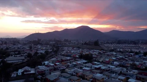 Ascending motion. Sunset in a cloudy day. Flying above a town. Stock Footage 158772376