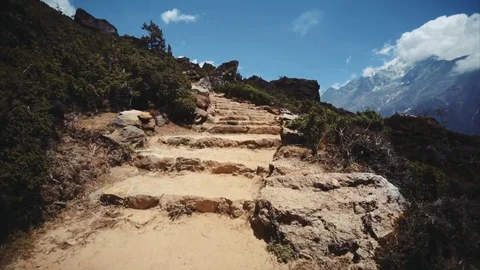 Ascending narrow Thame-Namche Bazaar path. Nepal Himalaya are on the background Stock Footage 72773481