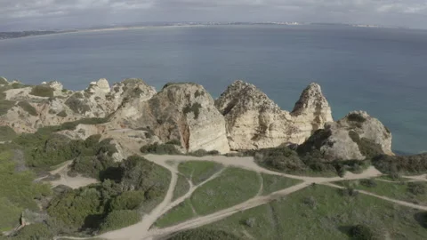 Ascending Orbit Tilt Down Aerial Of Cliffs By The Sea At Algarve Lagos 4K Stock Footage 167246817