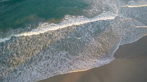 Ascending point of view above the seashore. Grazing light on the foam. Stock Footage 86641604