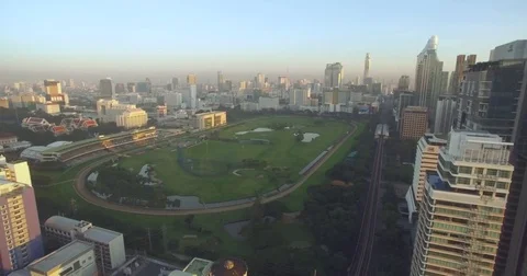 Ascending Pullback Aerial Shot Of Central Bangkok Park And Sports Ground Stock-Footage 73999333