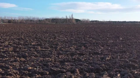 Ascending Pullback Drone Revealing Plowed Field After Harvest in Winter Stock Footage 325223154