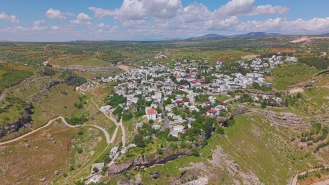 Ascending Pullback from a Historic White Stone Town Above a Scenic Lake 스톡 동영상 341021004