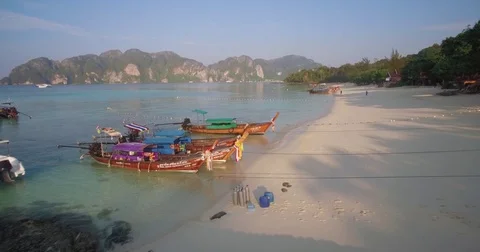 Ascending Pullback Shot of Longtail Boats and Speedboat on Long Beach, Phi Phi Stock Footage 78836555