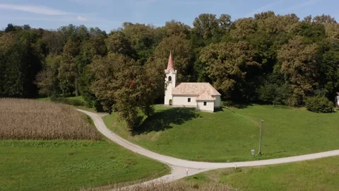 Ascending up tilting down shot of a charming rural church Stock Footage 285773323