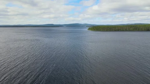 Ascending Windy Lake, Mountains in Background, Conifer Island Stock Footage 248901423
