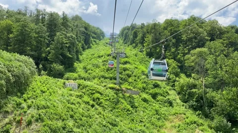 Ascent to the mountains by cable car. The view from the cockpit on the road a Stock Footage 136764265