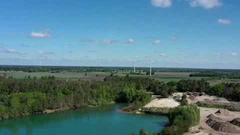 Ascent over the edge of the sand quarry with a view over the lake Stock Footage 130570115