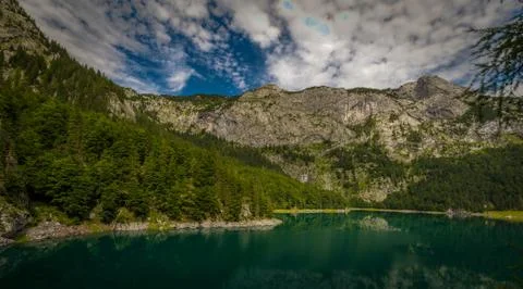 Ascent through green pine forest to Hochtor in national park Gesause Stock Photos