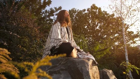 Ascetic meditates on the stone Stock Footage 80568474