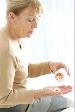  Ascorbic acid 60-year-old woman taking tablets of natural vitamin C. mode... Photos