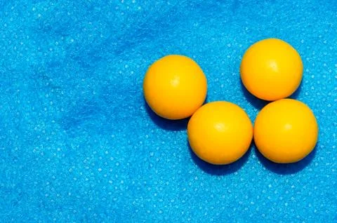 Ascorbic acid balls with vitamin C on a blue background. Prevention of colds. Stock Photos