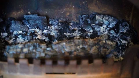 Ash and coal in the fireplace close-up, camera movement Stock Footage 309543989