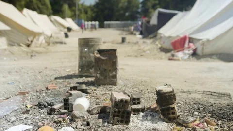 Ash and remains of born fire in the earthquake refugee camp Stock Footage 77452912