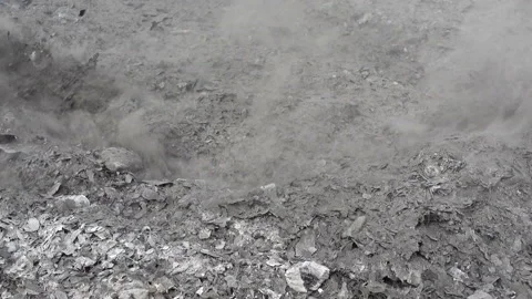 The ash of a burnt fire is touched with a stick Stock Footage 152465528