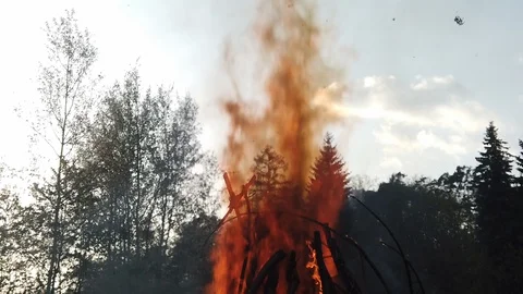Ash falls down as camera follows a blazing column of flame and smoke to Stock Footage 108169512