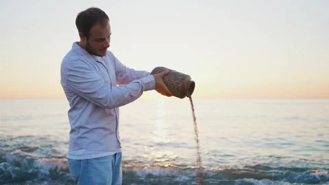 Ash scattering ceremony over the ocean at sunset ,beautiful sun Stock Footage 247337813