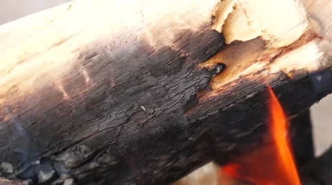 Ashes and flame on burning log in a fire Stock Footage 52372362