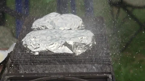 Ashes from a burning fire in a grill on which steaks are cooked. Video stock 277109774