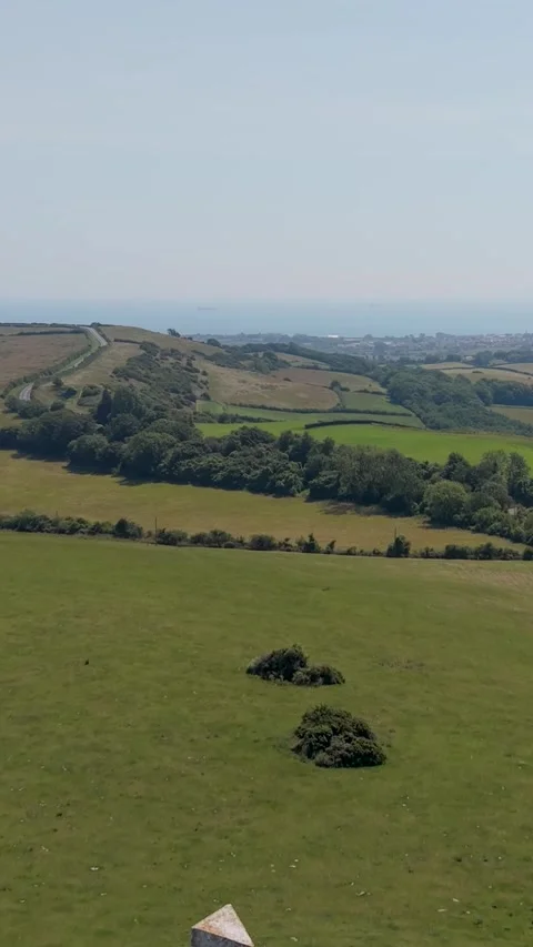 Ashey Down Sea Mark beacon drone rise over rolling farmland, Isle of Wight Stock Footage 339045424