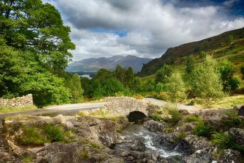 Ashness bridge over small stream in lake district Stock Photos