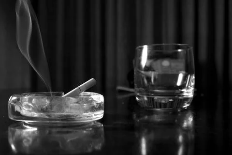 Ashtray and cigarettes on a table Stock Photos