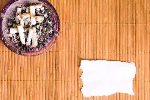 Ashtray and a note Stock Photos