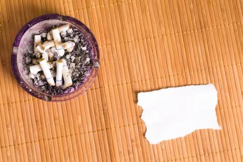 Ashtray and a note Stock Photos