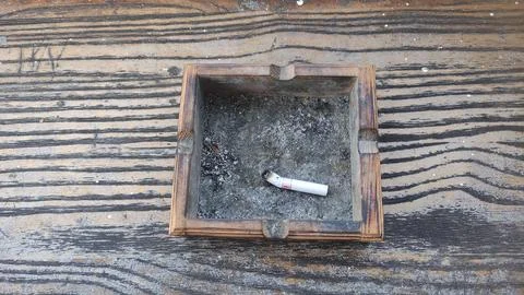 An ashtray with a cigarette. Stock Photos