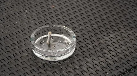 Ashtray with extinguished cigarette on the table. Bad habits concept. Ashtray Stock Photos