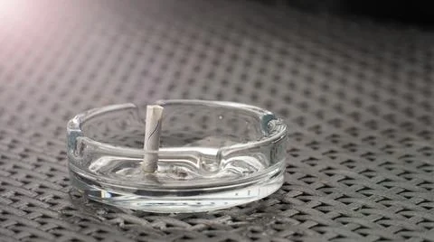 Ashtray with extinguished cigarette on the table. Bad habits concept. Ashtray Stock Photos