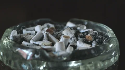 An ashtray full of cigarettes and ashes slider shoot