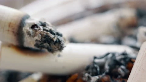 Ashtray full of cigarettes butts close-up, rusty depressive background. Stock Footage 155276628