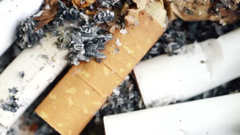 Ashtray full of cigarettes butts close-up, rusty depressive background. Stock Footage 155282507