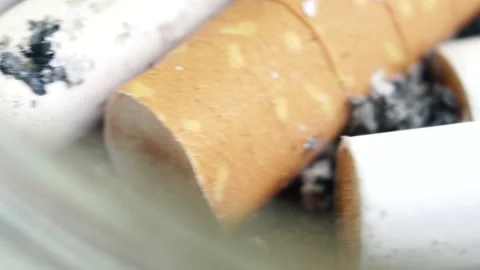 Ashtray full of cigarettes butts close-up, rusty depressive background. Stock Footage 155284054