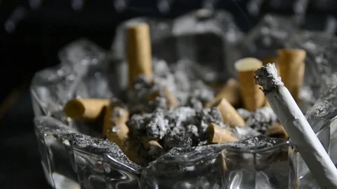 Ashtray full of cigarettes  pan motion left to right Stock Footage 102849154