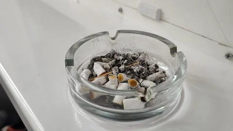 Ashtray full of cigars on white desk Video stock 285732479