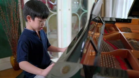 Asia boy learning piano Video stock 161066739
