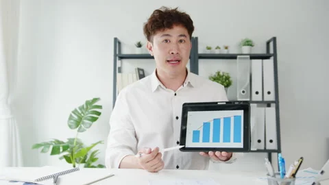 Asia businessman using tablet presentation to colleague about plan in video call Video stock 142158808