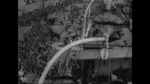 ASIA - CIRCA 1931: Troops assemble at a waterfront during military expansion Stock Footage 339065416