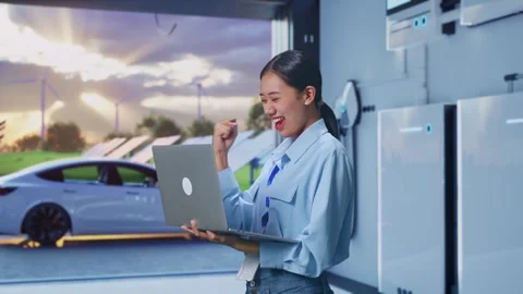 Asia Female Professional Worker Celebrating With Laptop With Energy Storage Stock Footage 295134553