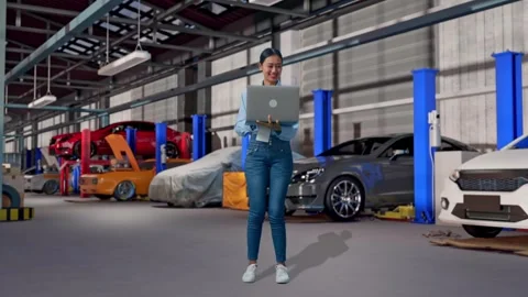 Asia Female Professional Worker Use A Laptop in Auto Repair Shop Stock Footage 313534082