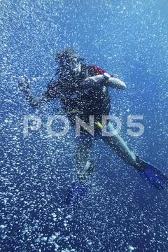 Asia, Indonesia, Bali, Scuba diver, Bubbles in clear blue ocean water Stock Photos
