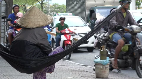 Asia inequality, poverty, selling on roadside, rush hour traffic, Vietnam Stock Footage