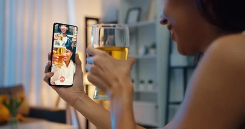 Asia lady drinking beer having fun night party event online by phone at home. Stock Footage 153189225