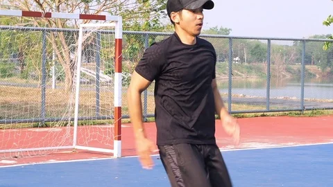 Asia Man Slow Motion Warm Up In Football Field. High Knee Spin Before Training. Stock Footage 106934938